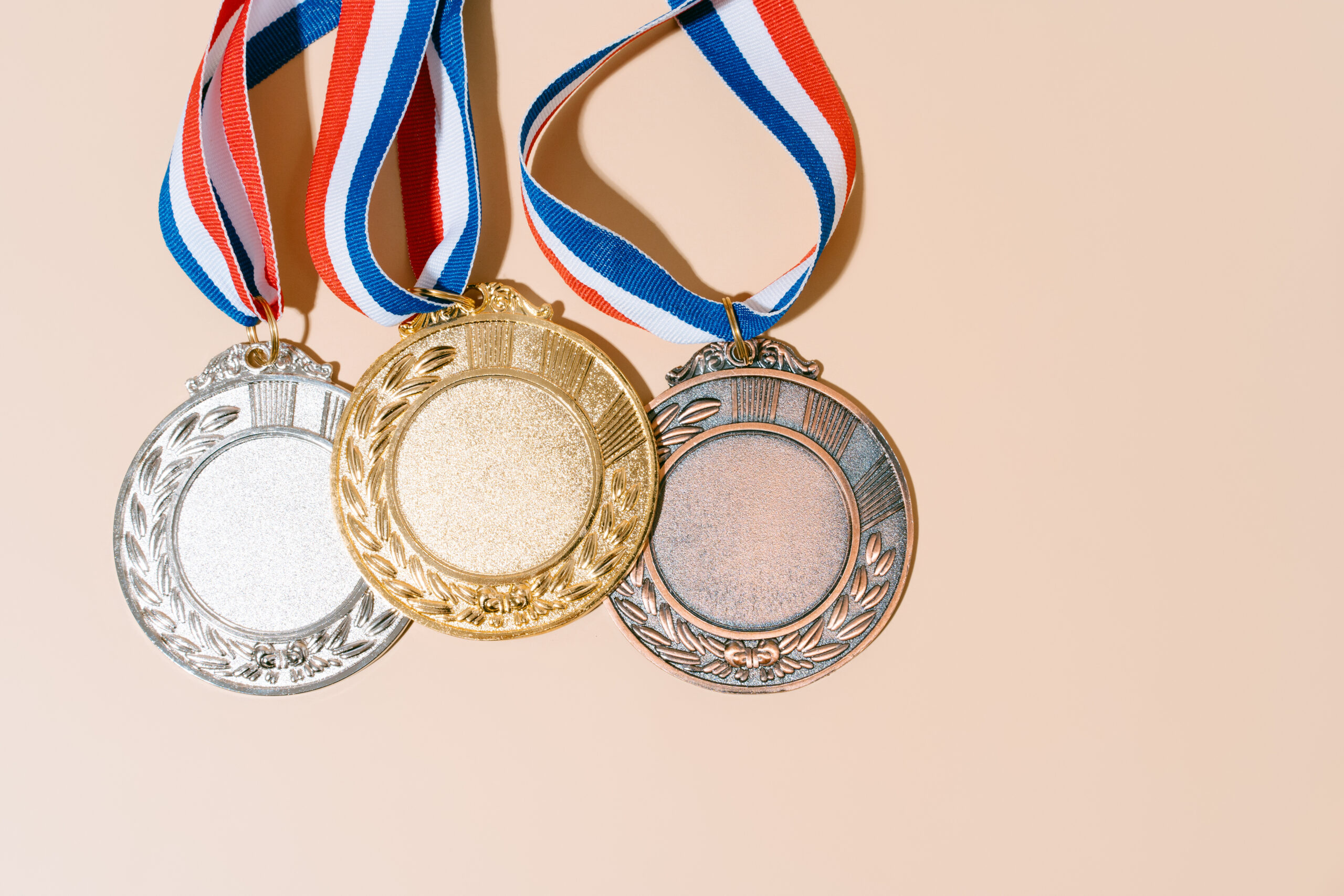 three medals (gold,silver,bronze) on pastel background.concept o