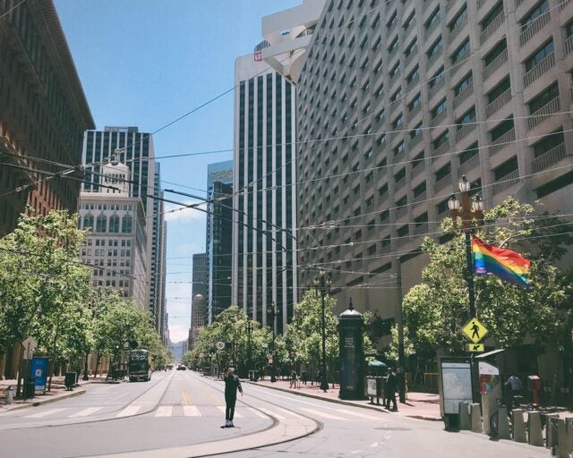 street with office buildings and a pride flag